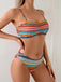 Multicolored striped bikini worn by a person against a neutral background