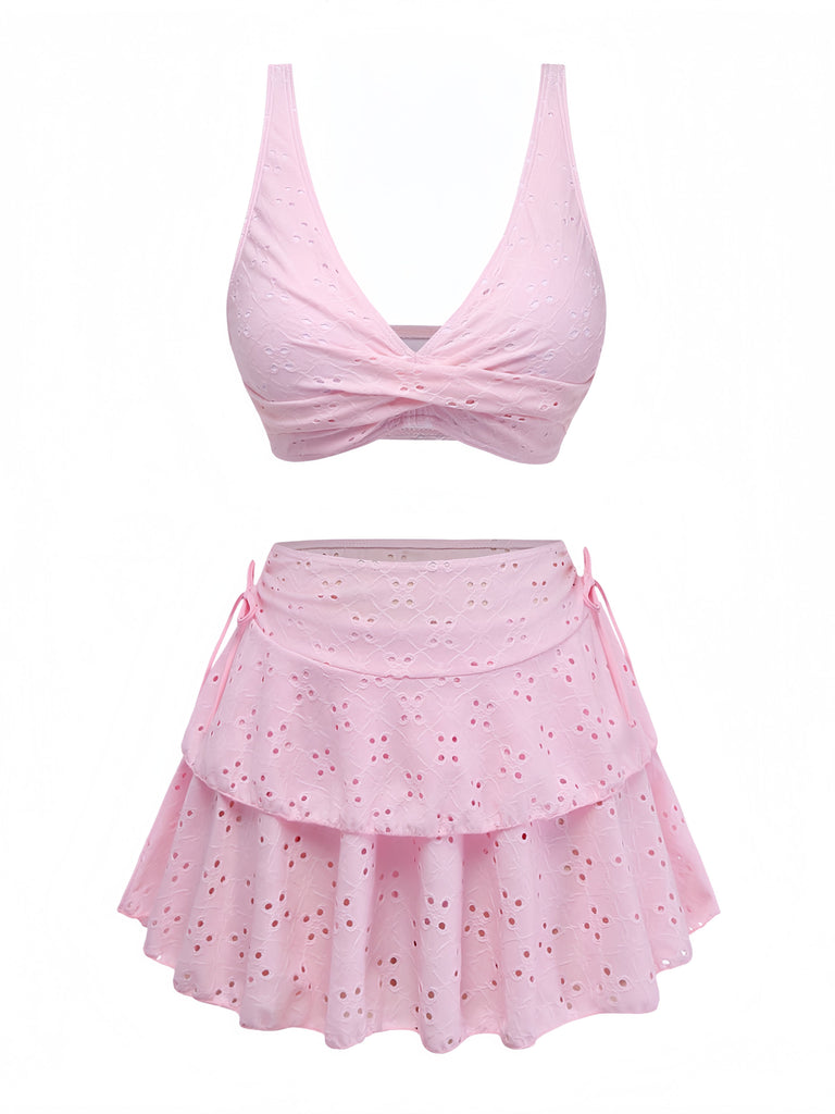 Pink two-piece swimsuit with a top and skirt on a white background