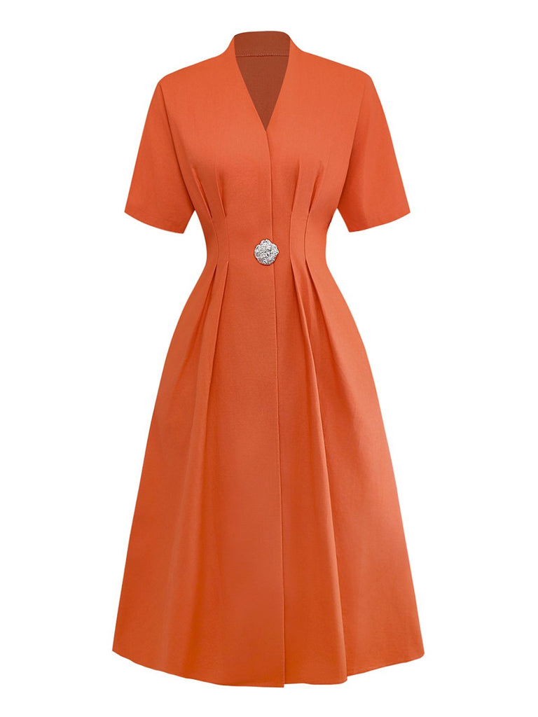 Robe unie orange à col en V et boutons et broche années 1940