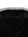 Black satin clutch with a silver embellished handle on a white background