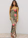 Woman wearing a floral dress with a plain background