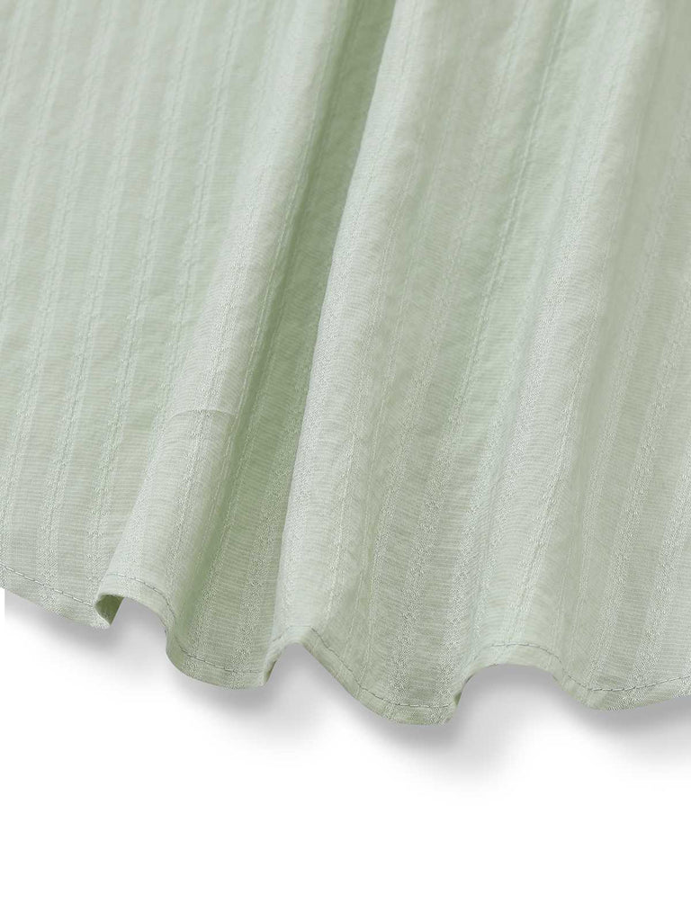 Chemisier vert col noué et manches bouffantes des années 80