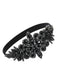 Objet circulaire noir avec la marque « UNIQUE » sur fond blanc