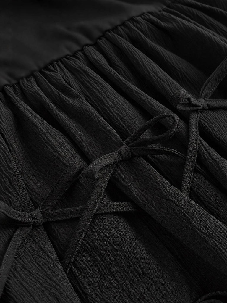 Robe patineuse noire nœuds papillon manches fines années 70