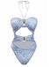 Un maillot de bain une pièce bleu clair imprimé denim, doté d'un col halter, de multiples découpes sur le devant et d'ornements métalliques dorés.
