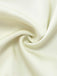 Macro shot of the soft, draped cream satin fabric used for the pajama shorts.