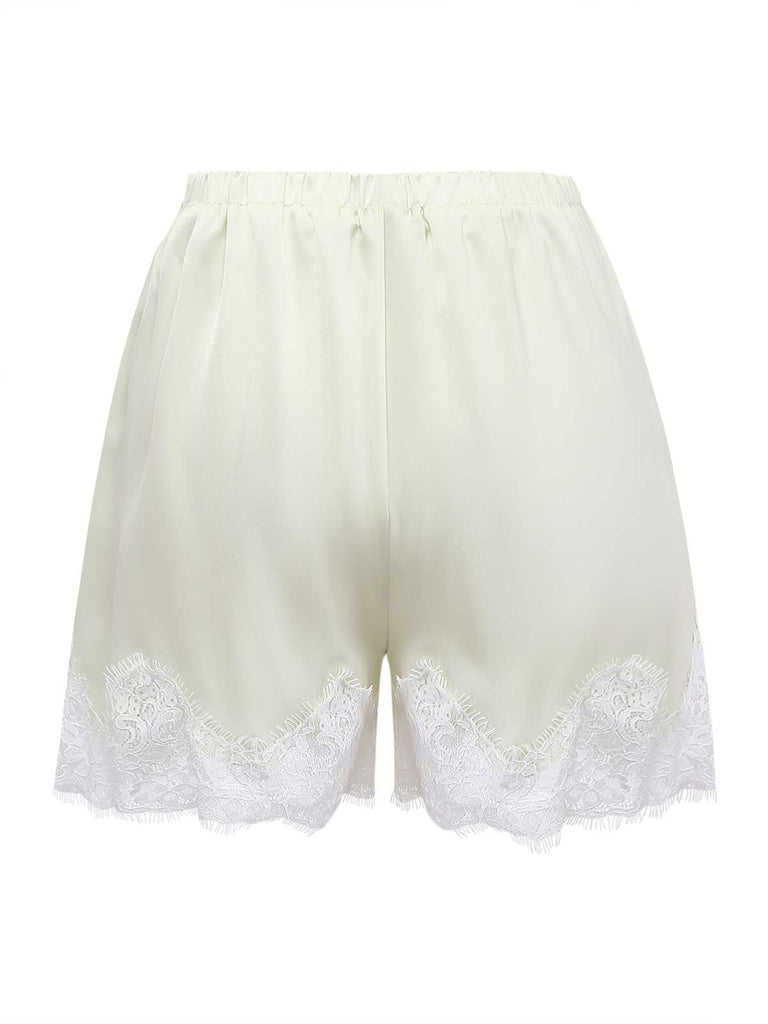 Back view of the cream satin pajama shorts highlighting the shimmering fabric and scalloped lace trim.