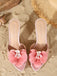 Top-down perspective of the light pink satin mules emphasizing the pointed toe and matching floral detail.
