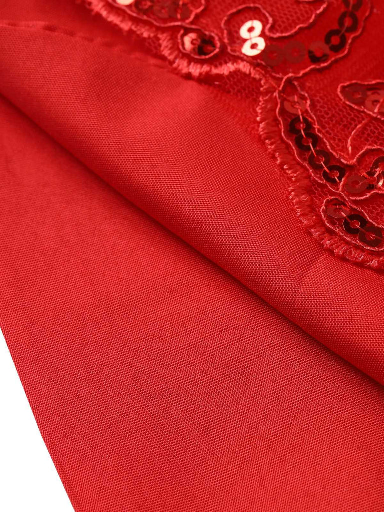 Detail shot of the smooth red satin lining underneath the sheer lace and sequin-embellished fabric.