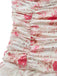 Close-up of the side ruching on the bodice, showing the pink rose and cursive text print on white fabric.