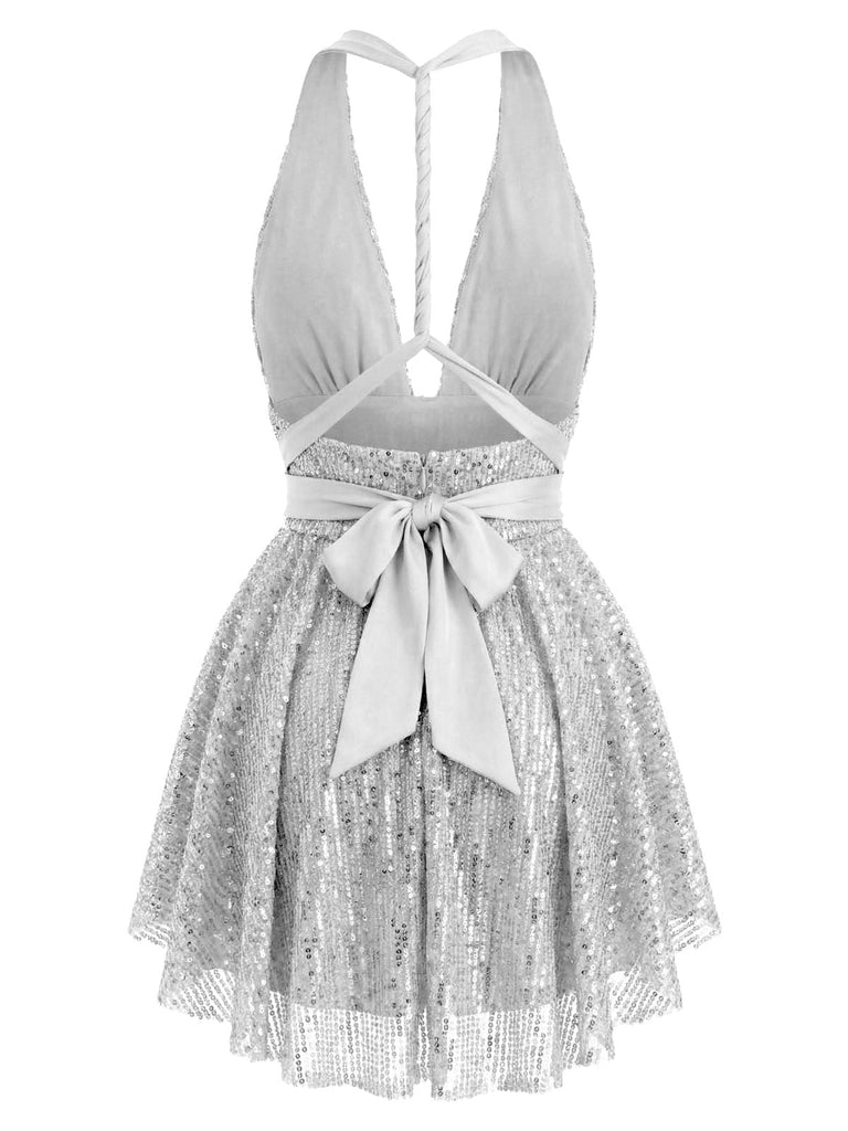 Back view of the silver sequin dress highlighting the shimmering fabric and layered skirt detail.