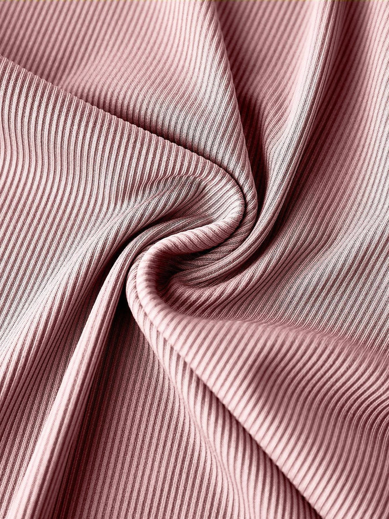 Close-up of the soft, breathable fabric texture and high-quality side seam stitching of the jumpsuit.